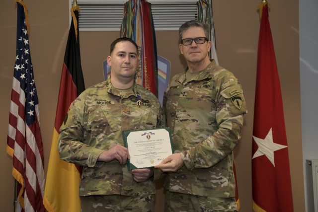 U.S. Army Maj. Gen. Peter Andrysiak, deputy commanding general for U.S. Army Europe and Africa presents Maj. Robert Morse, Chief of Theatre Operations for Regional Cyber Center-Europe, U.S. Army Cyber Command, with a Purple Heart for injuries he...