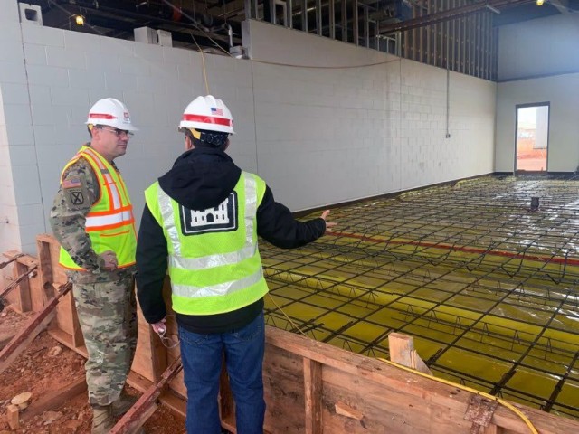 
Daniel de Robles, Area Engineer Tulsa District E&C Branch Tinker Air Force Base briefs USACE Chaplain Geoffrey Bailey during a visit to Tinker Air Force Base Dec. 23.  During the visit Bailey toured Tulsa District project on the base where he learned about the team’s mission. He also took time to meet the team and thank them for their hard work and professionalism as well as wish the staff a happy holidays.
