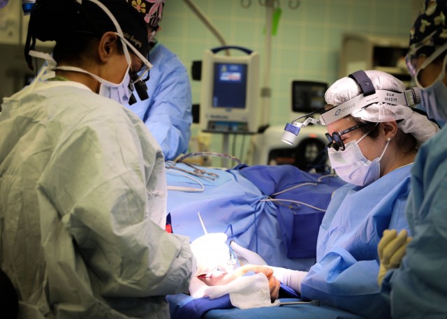 (From left) U.S. Army Lt. Col. Shimul Patel, chief, Plastic Surgery Services, Landstuhl Regional Medical Center,  and U.S. Army Lt. Col. Jessica Peck, chief, Ear, Nose and Throat Clinic, LRMC, operate on a cancer patient during the first microvascular reconstruction and anastomosis procedure ever performed at LRMC, Dec. 3. The first-of-its-kind procedure at LRMC expands services and capabilities at the only Level II Trauma Center outside the United States and principal evacuation and treatment center for all injured U.S. Service Members, civilians and Coalition Forces serving across Europe, Africa and the Middle East.  