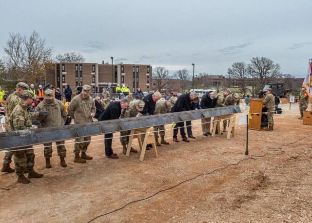 Leaders from the Defense Health Agency, the Army Health Planning Agency, the U.S. Army Corps of Engineers, the Maneuver Support Center of Excellence, and build and design contractors JE Dunn Construction and RLF Architects sign the final steel beam set to be installed in the new General Leonard Wood Army Community Hospital Dec. 7. 