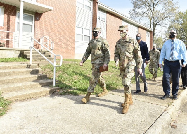 Col. Jeff Paine, U.S. Army Garrison Fort Leonard Wood commander (front right), speaks with community mayor, Staff Sgt. Ty Fogal, during the first walking town hall event here April 26, in the South Leiber Heights neighborhood. The goal of the monthly town hall has been to offer a casual environment for residents, where issues and concerns regarding privatized housing can be discussed with leaders. 