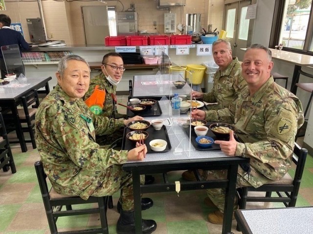 Maj. Christopher Tucker, a Civil Affairs Liaison Team Chief with the 9th Mission Support Command’s 322 Civil Affairs Brigade and his Japan Ground Self-Defense Force counterpart Lt. Col. Tsujita share a meal of udon noodles during a lunch break...