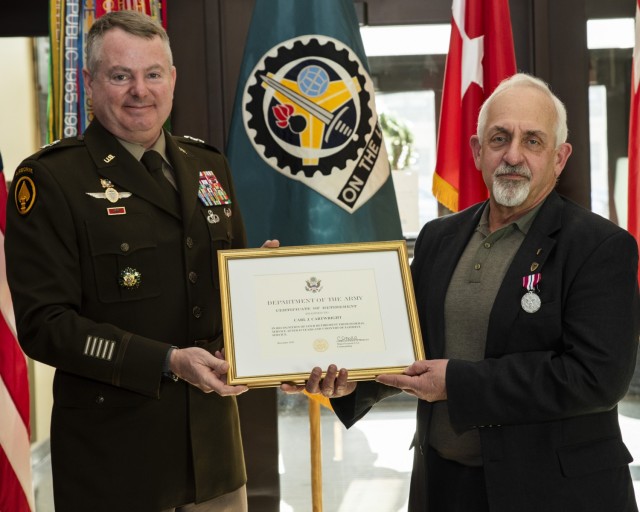 Maj. Gen. Chris Mohan, commanding general, U.S. Army Sustainment Command, presents a Certificate of Retirement to Carl Cartwright, executive director for Acquisition, Integration and Management, ASC, at Rock Island Arsenal, Illinois, Dec. 22....
