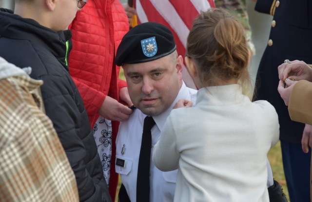 Col. John Nuckols surrounded by his children as they pin his new rank on his uniform during his promotion ceremony at Nallin Pond on December 17. (Photo Credit: Ramin A. Khalili, USAMRDC Public Affairs)