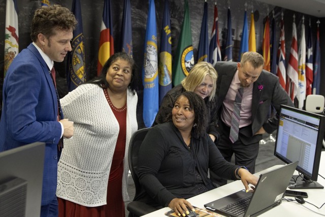 From left to right, Spencer Powell, Joyce Dean, Eddra Peoples, Cynthia Price and Scott Ferge, U.S. Army Financial Management Command systems accountants, talk through a problem during the Army’s mock fiscal yearend closeout at the Maj. Gen. Emmett J. Bean Federal Center July 19. Mock yearend is an exercise designed to prepare USAFMCOM and its partners for the fiscal yearend closeout and financial statement preparation at the start of October. (U.S. Army photo by Mark R. W. Orders-Woempner) 