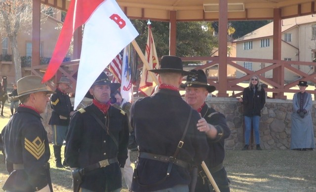 (Right) Col. Jarrod Moreland, Commander, U.S. Army Garrison-Fort Huachuca passes the unit guidon and pats incoming Commander John Walton as the unit outgoing Commander Eduardo Gonzalez and 1st Sgt. Pete Criscuolo looks on at the B Troop, 4th U.S....