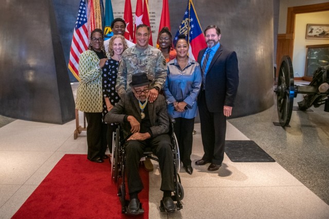 Retired Command Sgt. Maj. Edward Garrett (sitting) and family pose for a photo during an award ceremony at the National Infantry Museum, Columbus, Ga. on Jan. 7. Photo by Patrick A. Albright