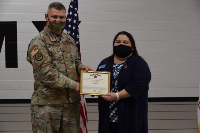 Tina Bevier, director, Community/Installation Outreach Services, Child & Youth Services, receives the certificate for the Civilian Service Achievement Medal from Col. Todd Allison, garrison commander, U.S. Army Garrison Rock Island Arsenal, as...