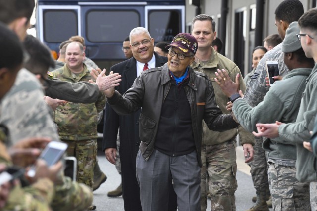 Former Tuskegee Airman, retired Col. Charles McGee, high-fives Airmen during his visit Dec. 6, 2019, at Dover Air Force Base, Del. He served a total of 30 years in the U.S. Air Force, beginning with the U.S. Army Air Corps, and flew a total of 409 combat missions in World War II, Korea and Vietnam. The Tuskegee program began in 1941 when the 99th Pursuit Squadron was established, and its Airmen were the first ever African-American military aviators in the U.S. Army Air Corps. (U.S. Air Force photo by Senior Airman Christopher Quail)