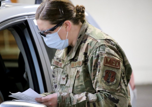 Staff Sgt. Melinda Grounds, a medic with the 141st Medical Group and a registered nurse in Idaho, goes through a questionnaire with a visitor to the mass vaccination site at the Clark County Fairgrounds in Ridgefield, Wash. Jan. 28, 2021. About...