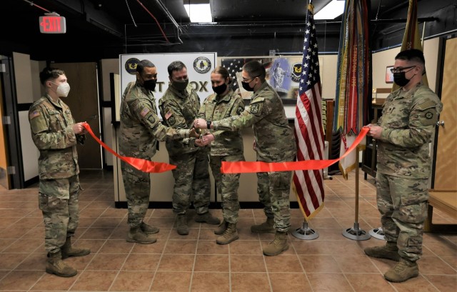 Fort Knox leaders join Capt. Summer Prather, Fort Knox Tax Center lead officer, in cutting the ribbon Jan. 21, 2022, to mark the grand opening of the center.