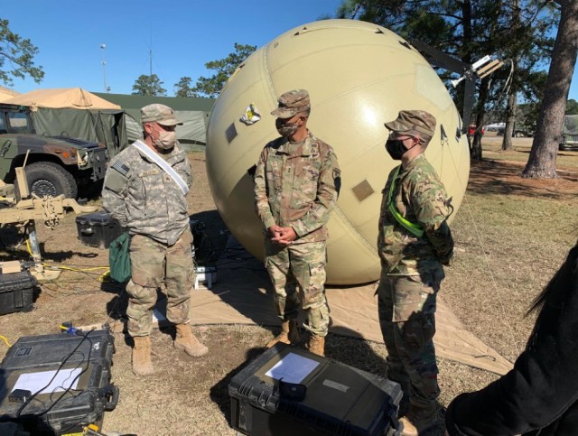 Maj. Gen. Robert Edmonson meets with 1st Infantry Brigade Combat Team, 10th Mountain Division signal Soldiers in front of the Satellite Transportable Terminal during Reception, Staging and Onward Integration at JRTC, Fort Polk.