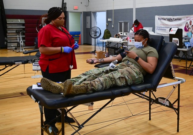 An American Red Cross donation technician monitors a Fort Jackson Soldier as she donates a pint of whole blood during a community blood drive held at Coleman Gym. One pint of blood has the potential to save three lives. Each donation can be...