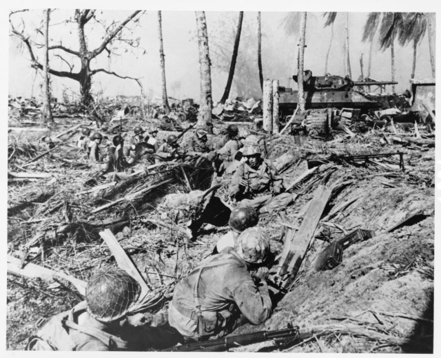 Soldiers advancing against entrenched Japanese on Kwajalein Atoll during Operation Flintlock, Jan. 31 - Feb 4, 1944. 