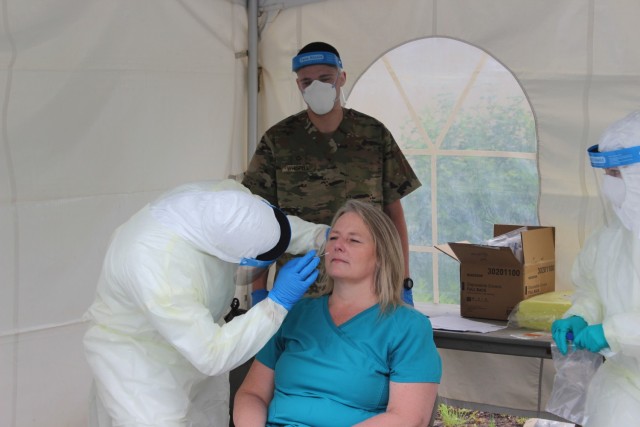Staff Sgt. Kursty Campbell, left, and Pfc. Ryan Whispell, center, test a staff member at Kendal-Crosslands Nursing Home in Kennett Square, Pa., May 26, 2020. (Photo by Master Sgt. George Roach)