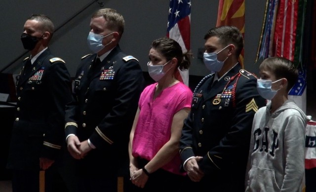(left) Col. Crayton Simmons, Director, Doctrine and Intelligence Systems Training, Lt. Col. Andrew Maas and family stand in the Greely Hall Auditorium as the Soldier formally retires after 20 years of military service at a ceremony on Fort Huachuca, Ariz. 