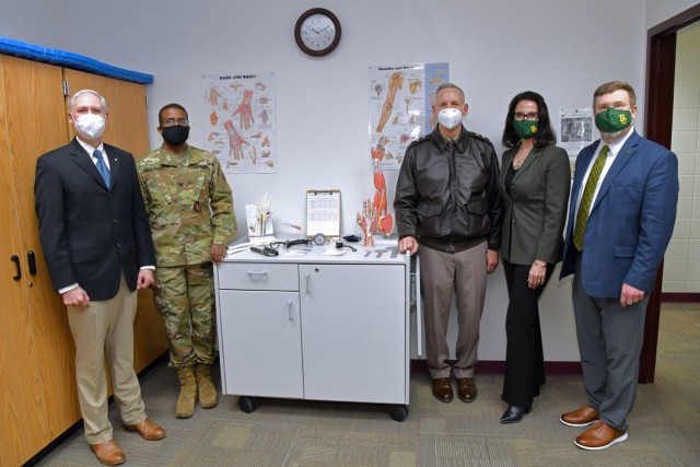 Maj. Gen. Dennis P. LeMaster, U.S. Army Medical Center of Excellence commanding general (third from the left) along with (from left) retired Col Skip Gill, Col Enrique Smith-Forbes, Dr. Sheri Dragoo and Dr. Denny Kramer pose in front of a display at the new Army-Baylor Occupational Therapy Doctorate Program lab.