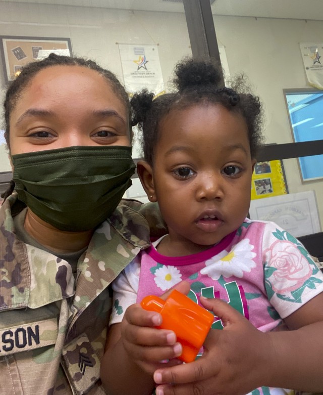 Sgt. Jennifer Jackson,  noncommissioned officer in charge of health physics for Public Health Command-Pacific at Camp Zama, Japan, poses for a photo with her godchild, Zayah. After helping a pregnant Soldier, who had arrived alone to Japan, adjust to her new life, Jackson was surprised when the Soldier asked her to be in the delivery room to witness the birth of Zayah. Helpfulness is a quality that Jackson had ingrained in her from a young age. Her parents taught her as a child to be caring, responsible and to earn things with hard work, she said.