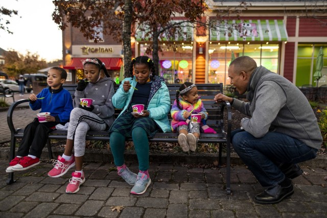 Benjamin Spencer, dean of the William & Mary Law School and a U.S. Army Reserve captain, jokes around with his youngest daughter while four of his nine children sit on a bench together eating frozen yogurt in Williamsburg, Virginia, Dec. 2, 2020. Spencer is the first African-American dean hired by the oldest law school in the country and a U.S. Army Reserve officer and lawyer who works for the Government Appellate Division. Spencer graduated from Harvard Law School and joined the Army when he was almost 41 because he felt a calling to serve people and serve his nation. (U.S. Army Reserve photo by Master Sgt. Michel Sauret)
