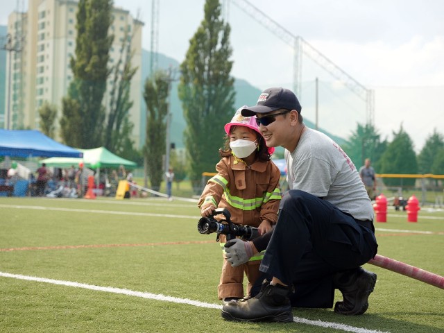 A junior firefighter prepares to douse some cardboard targets during an obstacle course event at Camp Walker, Republic of Korea. The event was just one of many hosted by USAG Daegu Emergency Services during an open house on October 9, 2021.