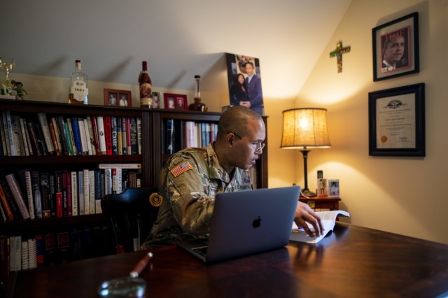 Capt. Benjamin Spencer, a U.S. Army Reserve lawyer who works for the Government Appellate Division, reviews a courts-martial manual in his home office in Williamsburg, Virginia, Dec. 2, 2020. Spencer is the dean of the William & Mary Law School and the first African-American dean hired by the oldest law school in the country. Spencer graduated from Harvard Law School and joined the Army when he was almost 41 because he felt a calling to serve people and serve his nation. (U.S. Army Reserve photo by Master Sgt. Michel Sauret)