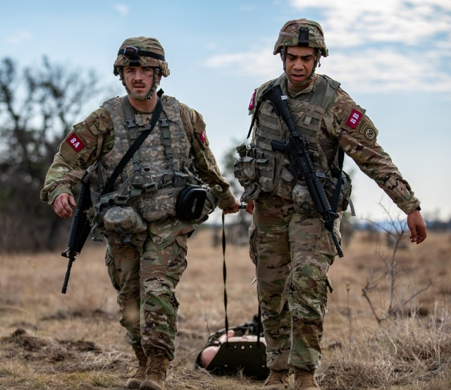 U.S. Army Sgt. Ethan Hart and Staff Sgt. Dylan Delamarter, 2nd Battalion, 108th Infantry, 27th Infantry Brigade Combat Team, New York Army National Guard,  transport a simulated casualty during the Army&#39;s Best Medic Competition at Fort Hood,...