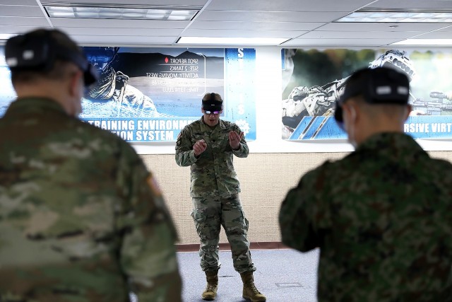 Lt. Col. Kyle Yanowski, TRADOC Proponent Office-Synthetic Training Environment (center) talks Combined Arms Center-Training Deputy Commanding General Brig. Gen. Charles Lombardo and Maj. Gen. Shinichi Aoki, Japanese Ground Self Defense Force through the capabilities of a mixed reality headset during Aoki’s visit to the Combined Arms Center-Training Innovation Facility, Fort Leavenworth, Kan., Feb. 7, 2022. Photo by Tisha Swart-Entwistle, Combined Arms Center-Training Public Affairs.