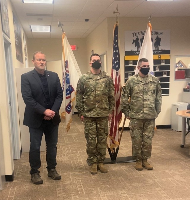 Staff Sgts. Justin Faust and Justin LaMar receive the Army Commendation Medal Jan. 31 for providing lifesaving first aid to a stabbing victim at their recruiting station in Bismarck, North Dakota. Bismarck mayor Steve Bakken presented the awards.