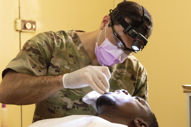 U.S. Army Maj. Anthony Gragg, a dentist with the Medical Detachment, Garrison Support Command, Vermont National Guard, examines a patient at the Regional Center Hospital at Tambacounda, Senegal, April 12, 2019. The National Guard’s State...