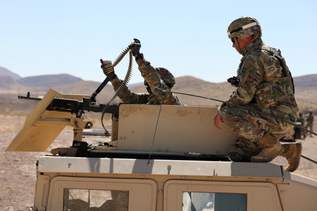 Sgt. Javier Stoneburner, observer coach/ trainer from the 85th U.S. Army Reserve Support Command’s 3-360th Training Support Battalion, observes a Tennessee National Guard Soldier from the 268th Military Police Company load ammunition into an...