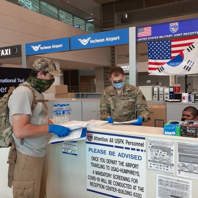 1st Lt. Eric Umans of 662nd Movement Control Team speaks with a newly-arrived passenger at Incheon International Airport.
