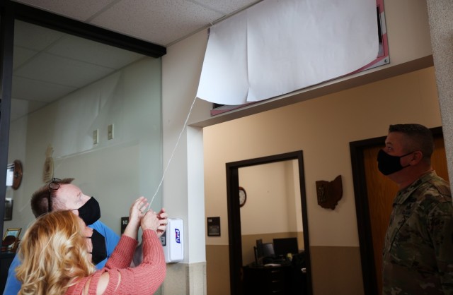 Family of former Casualty Assistance Center employee attends tear-filled wing naming ceremony