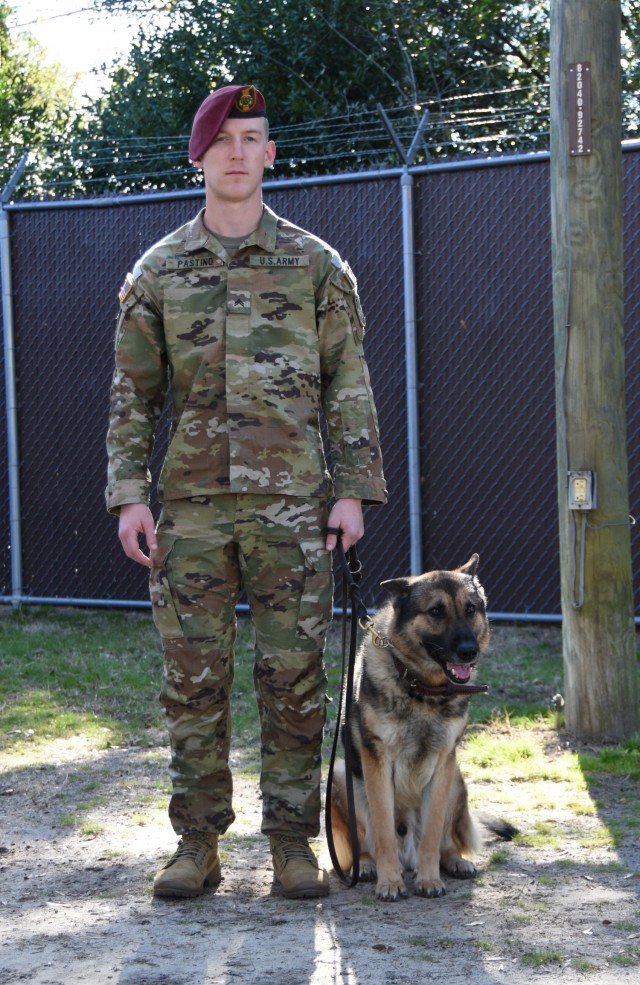 Cpl. Anthony Pastino, stands with Military Working Dog, Mex, one of 24 dogs currently assigned to the 550th MWD Detachment. Pastino is what is known as a &#34;handler&#34; and works with Mex to ensure his skills are always top-notch.