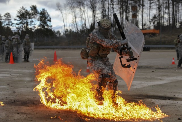 A U.S. Army Soldier assigned to Kentucky National Guard’s 1st Battalion, 149th Infantry Brigade, 116th Infantry Brigade Combat Team, 29th Infantry Division, reacts to a Molotov cocktail during fire phobia training at the Joint Multinational Readiness Center, Hohenfels, Germany, Feb. 11, 2022. Fire phobia training is conducted during mission rehearsal exercises before deployment.
 (U.S. Army photo by Sgt. Marla Ogden)