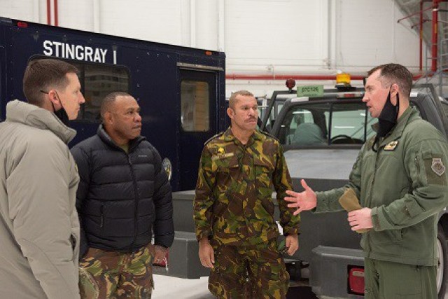 Military leaders from Papua New Guinea speak with Wisconsin National Guard leaders from the 115th Fighter Wing Feb. 5, 2022, in Madison, Wis., during a historic first visit to Wisconsin through the State Partnership Program. The program links...