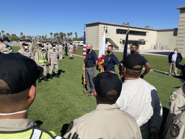 Service members from the Joint Armed Forces Color Guard and The U.S. Army Band conduct a skills clinic for students from the Sunburst Youth Academy on Joint Training Base Los Alamitos, California, February 12, 2022. The color guard and drummers were in California to present the colors for Super Bowl LVI.
