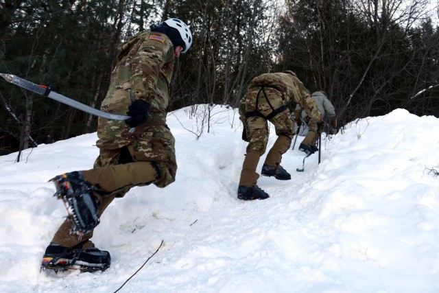 Students at the U.S. Army Mountain Warfare School’s Basic Military Mountaineer Course practice traversing in crampons and learning to stop a fall with ice axes Jan. 21, 2022. The AMWS is a U.S. Army Training and Doctrine Command school operated by the Vermont Army National Guard at Camp Ethan Allen Training Site, Vermont.
