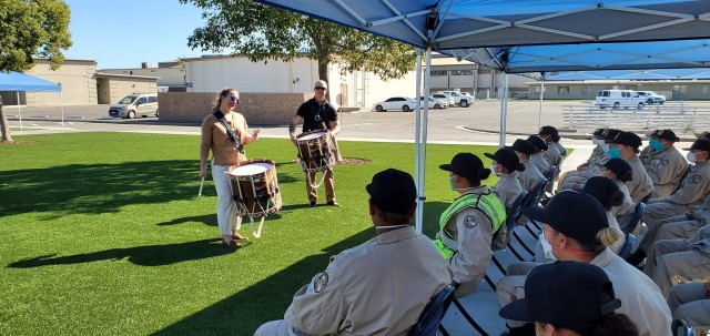 Service members from the Joint Armed Forces Color Guard and The U.S. Army Band conduct a skills clinic for students from the Sunburst Youth Academy on Joint Training Base Los Alamitos, California, February 12, 2022.
The color guard and drummers were in California to present the colors for Super Bowl LVI.