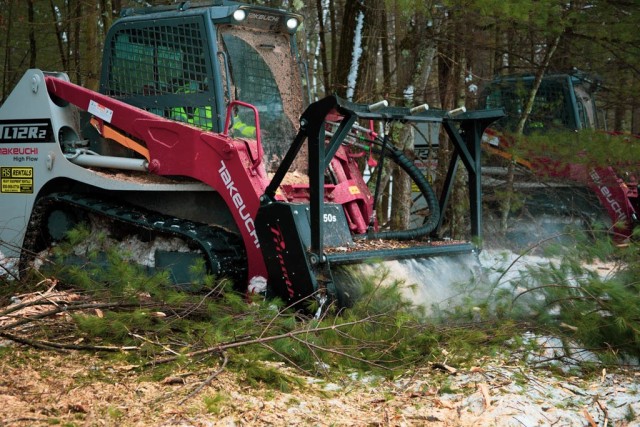 Forestry heavy equipment operators mulching a tree