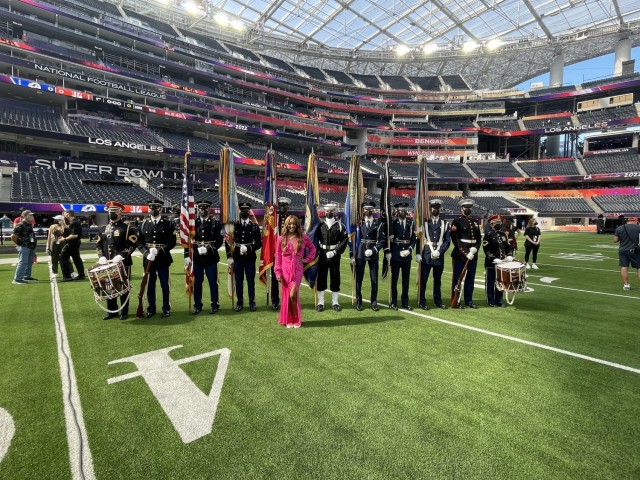 A Joint Armed Forces Color Guard and drummers from The U.S. Army Band present the colors during the national anthem at Super Bowl LVI. Each of the eleven service members from the National Capital Region were selected by their service honor guard...