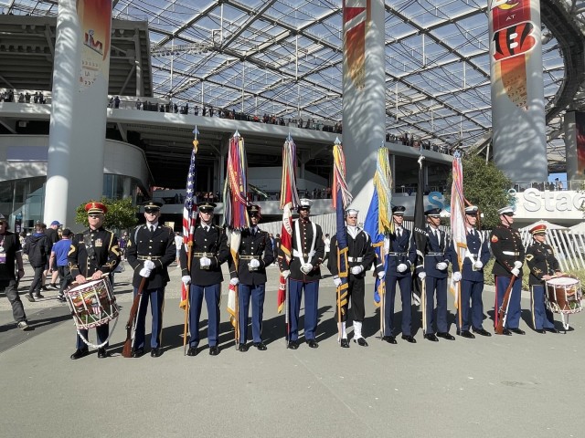 A Joint Armed Forces Color Guard and drummers from The U.S. Army Band present the colors during the national anthem at Super Bowl LVI. Each of the eleven service members from the National Capital Region were selected by their service honor guard...