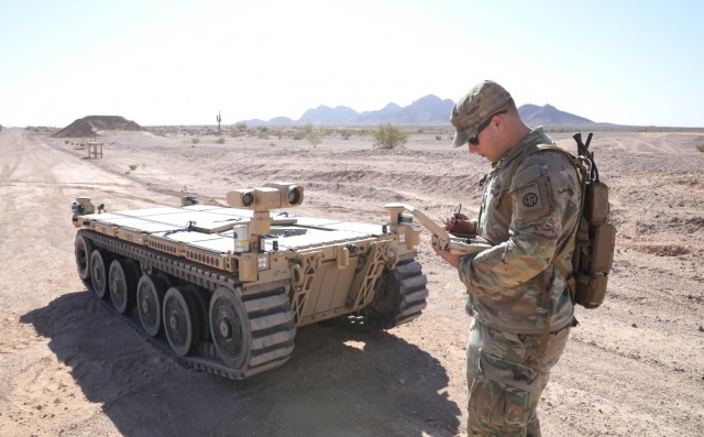 U.S. Army Pfc. Daniel Candales uses the tactical robotic controller to control the EMAV.