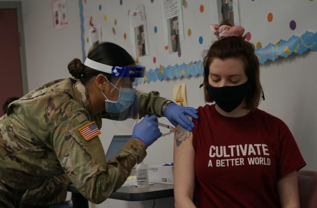 Spc. Han Thach, left, a combat medic with the Pennsylvania National Guard, administers the COVID-19 vaccine to a patient in Enola, Pa., March 26, 2021. Thach was part of the Guard mission to vaccinate Pennsylvania teachers, child-care workers and other staff. (U.S. Army photo by Sgt. 1st Class Matthew Keeler)