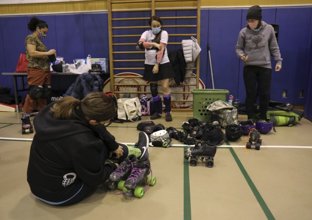 Skaters put on their gear for the first practice of the Zama Killer Katanas roller derby team after a hiatus due to the pandemic at Arnn Elementary School, Sagamihara Family Housing Area, Japan, Feb. 22, 2022.