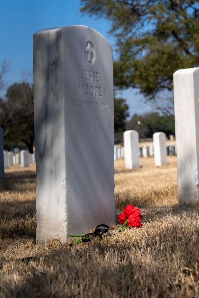 Flowers mark the 17 Soldiers’ graves of the 24th Infantry Regiment, who were involved in the Houston Riot of 1917.These Soldiers, and regiment were recognized with an interpretative marker during an unveiling ceremony, held at the Fort Sam Houston National Cemetery, San Antonio, Texas, Feb. 22, 2022. (U.S. Army Photo by Bethany Huff)