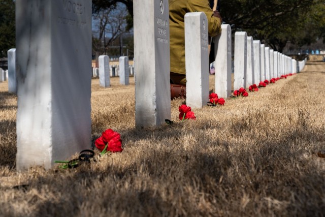 Flowers mark the 17 Soldiers’ graves of the 24th Infantry Regiment, who were involved in the Houston Riot of 1917.These Soldiers, and regiment were recognized with an interpretative marker during an unveiling ceremony, held at the Fort Sam Houston National Cemetery, San Antonio, Texas, Feb. 22, 2022. (U.S. Army Photo by Bethany Huff)