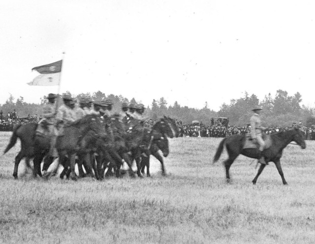 Buffalo Soldiers from the 9th Cavalry Regiment pass in review following the American Lake Maneuvers of 1904