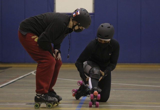 Hannah Howard, left, a coach for the Zama Killer Katanas, talks with Master Sgt. Shanika Johnson, senior enlisted adviser for Army Reserve Affairs at U.S. Army Japan, during the roller derby team's first practice at Arnn Elementary School,...