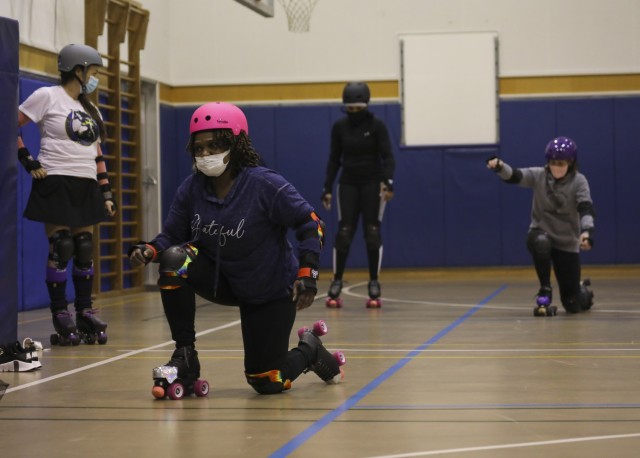 Skaters conduct a knee slide drill during a practice for the Zama Killer Katanas at Arnn Elementary School, Sagamihara Family Housing Area, Japan, Feb. 22, 2022.