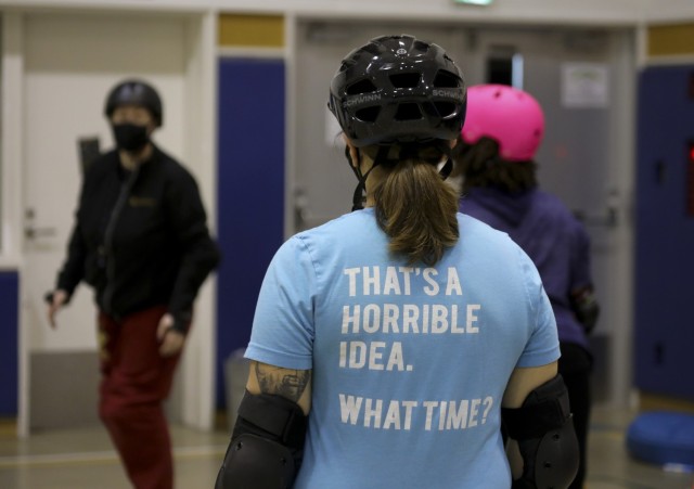Hannah Howard, left, a coach for the Zama Killer Katanas, goes over a drill with other skaters during the roller derby team&#39;s first practice at Arnn Elementary School, Sagamihara Family Housing Area, Japan, Feb. 22, 2022.